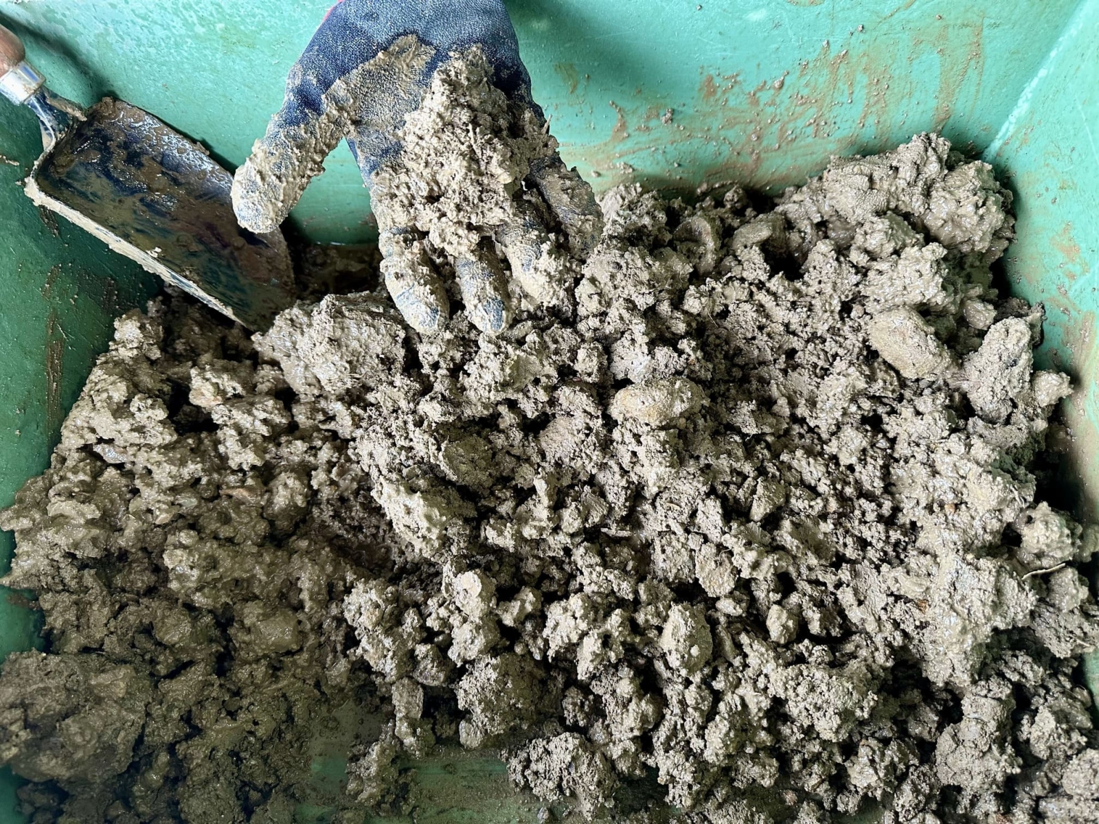 配合試験前の土砂を手で示している様子